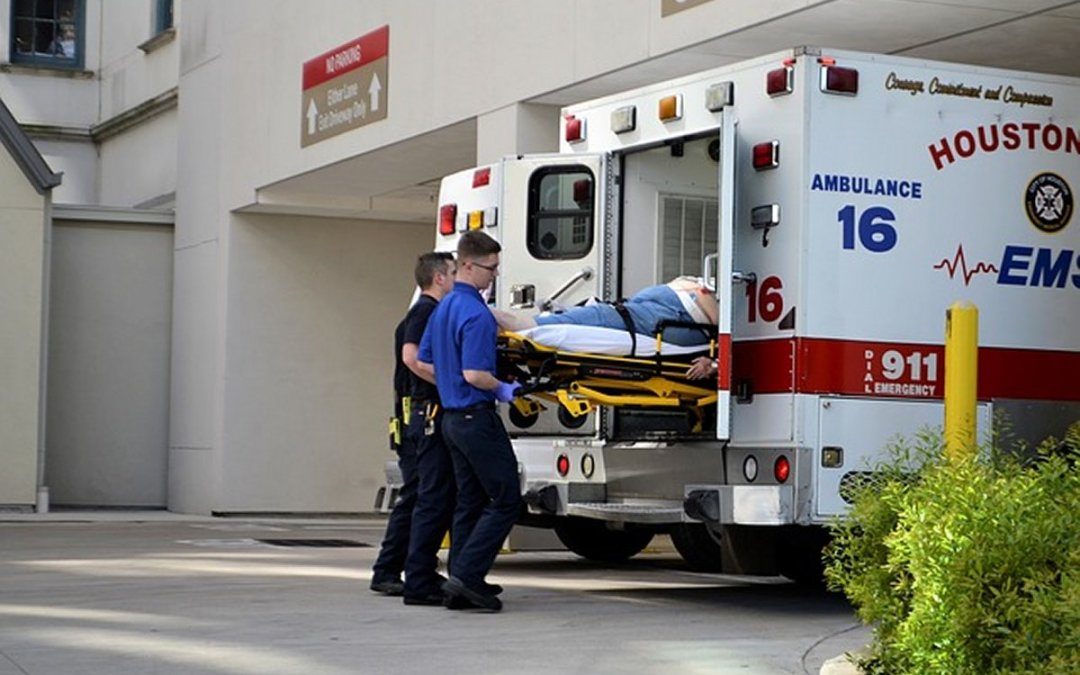 First responders in Houston, TX place gurney into ambulance