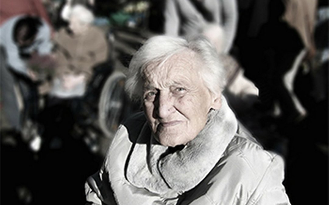 Elderly female looking into camera with blurred images of activity all around her