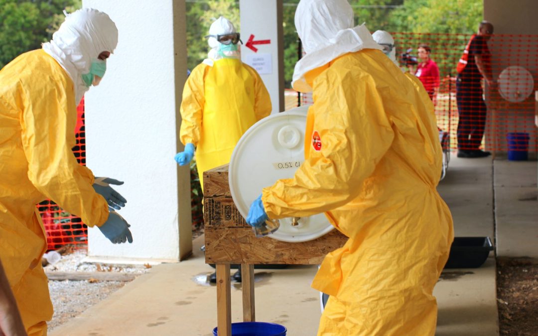 people in hazmat suits cleaning up toxic spill