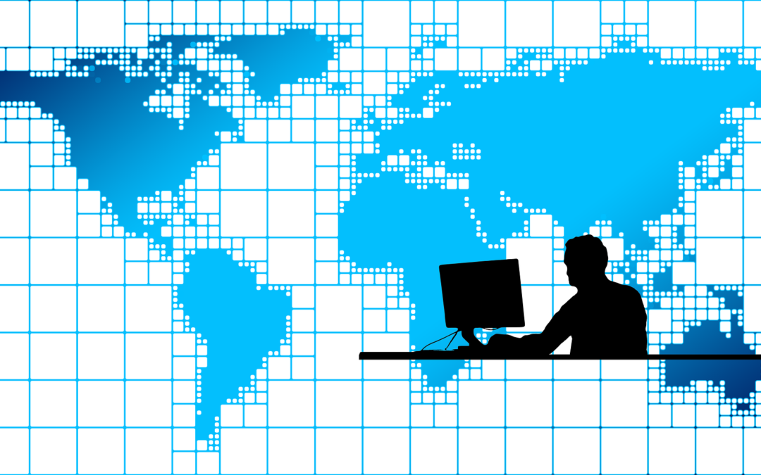 World map with silhouette of person at desktop computer