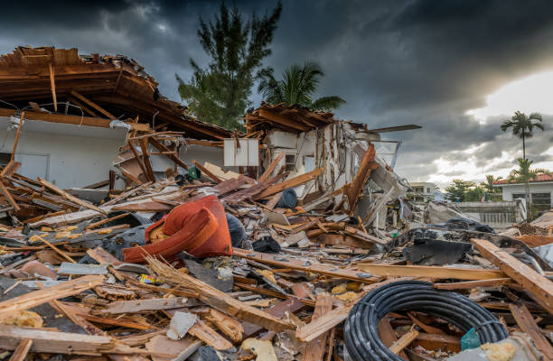 House and business destruction from tornado. Wood, shingles, piping strewn about.